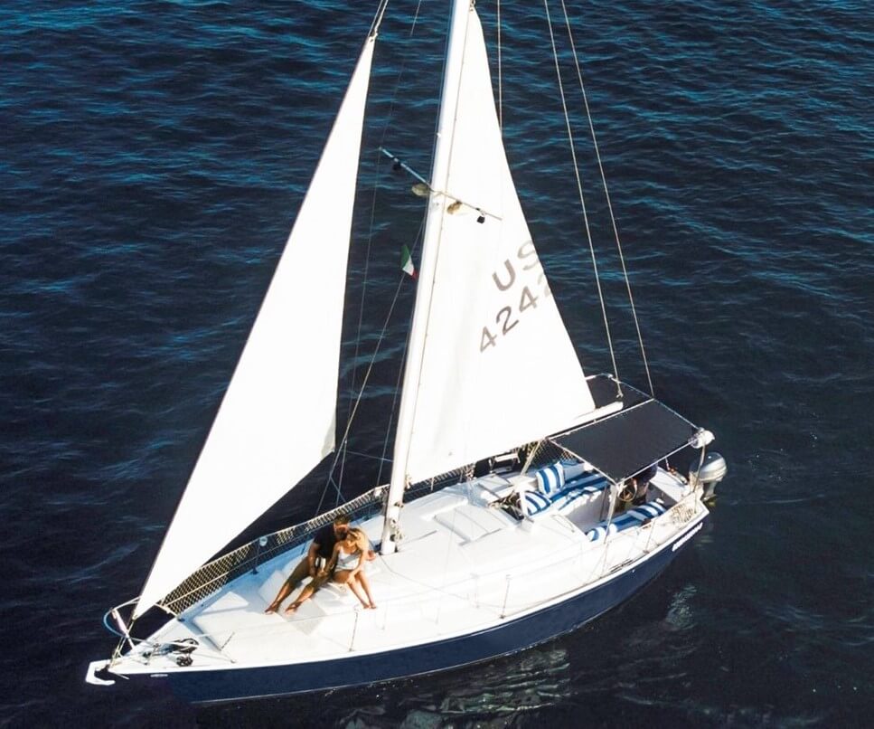 A couple of people on a sailboat